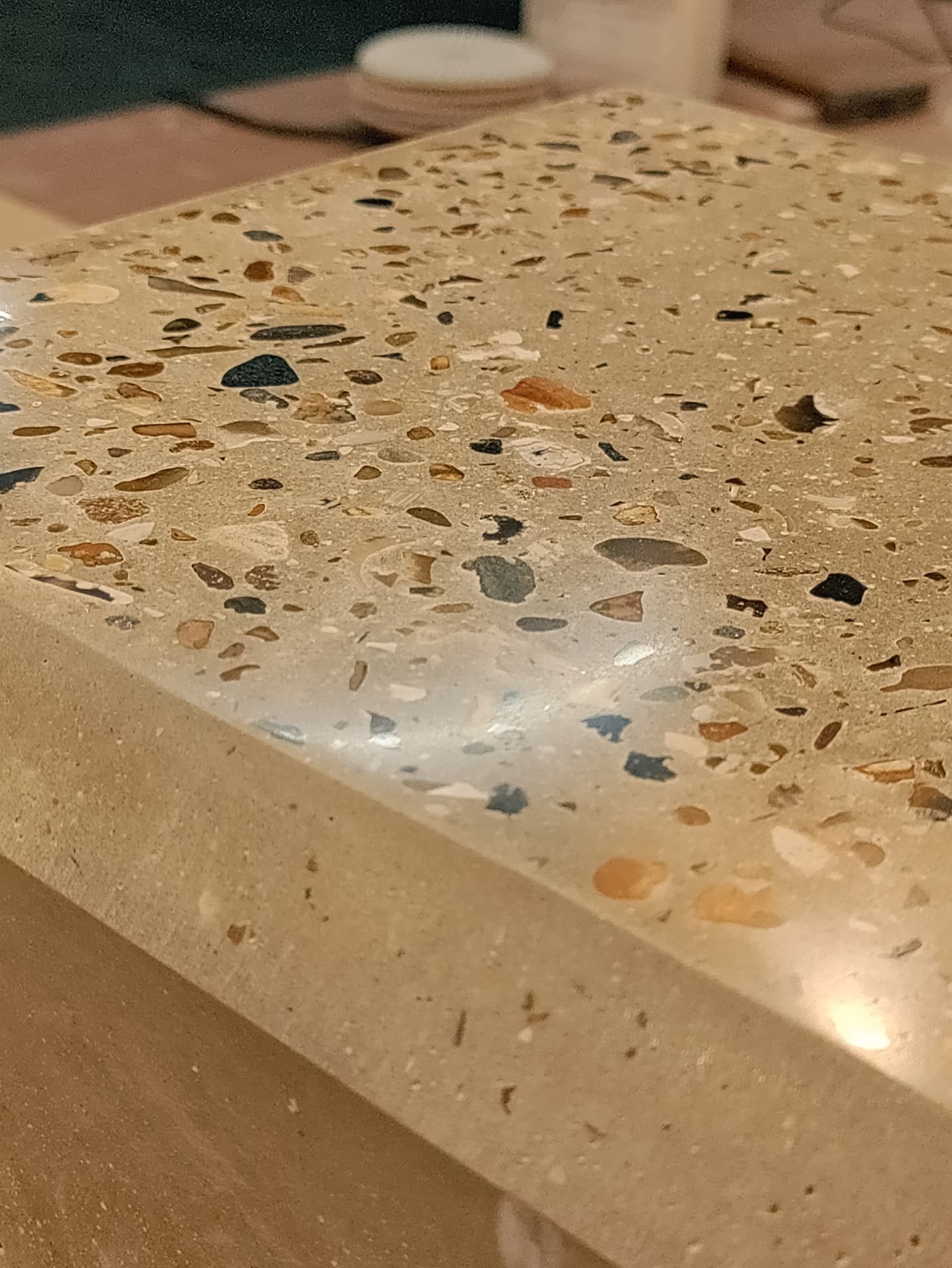 Hand-polished terrazzo edge of a cast concrete counter